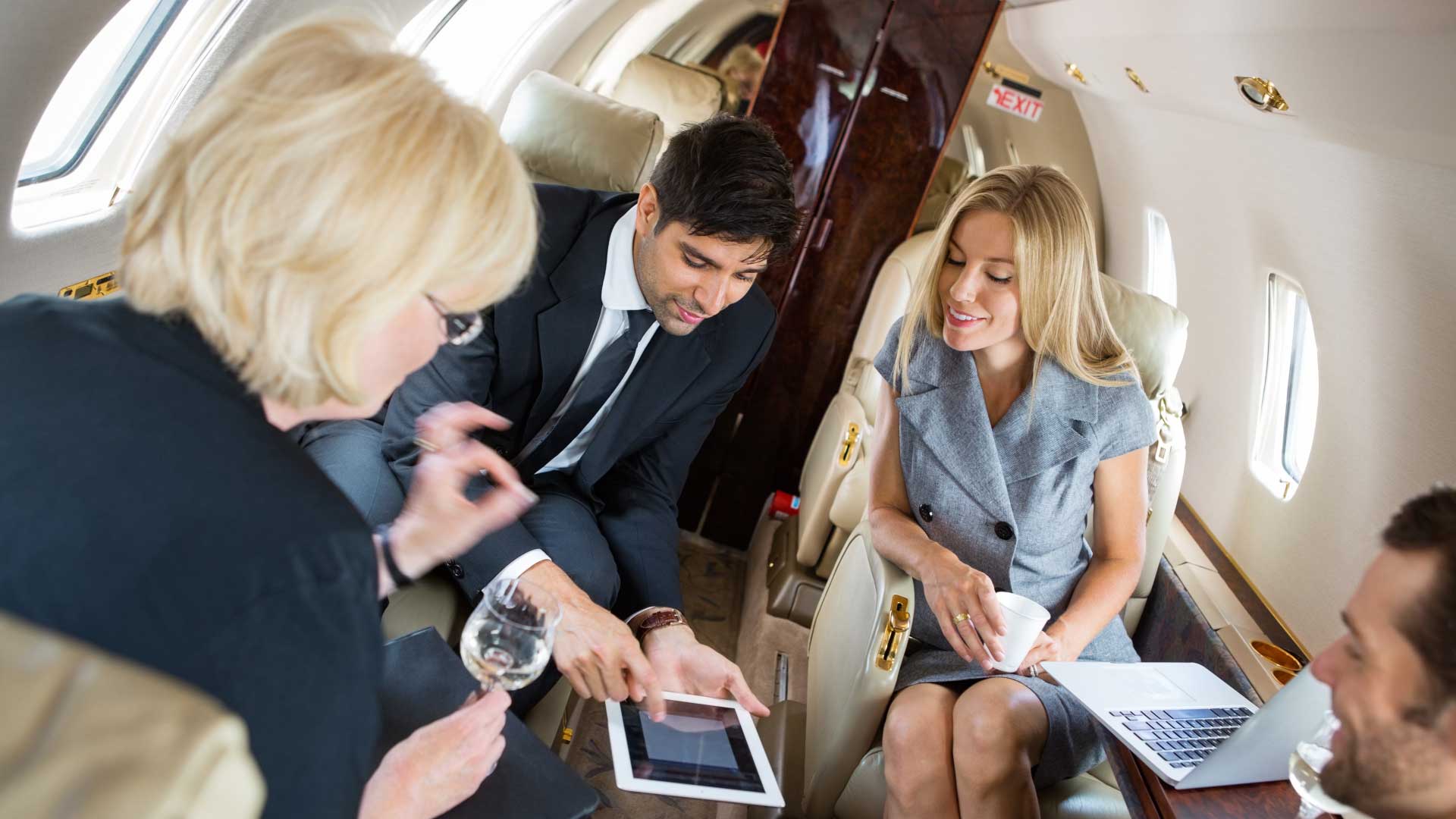 Corporate team having a meeting aboard a private jet, representing La Casa Jet’s services for corporate flight departments.